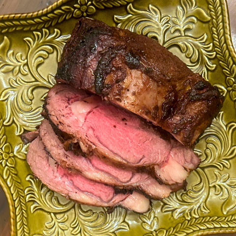 Smoked Bison roast on green plate 