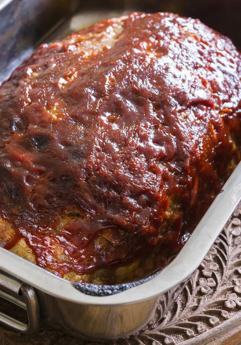 Cooked bison meatloaf in pan 