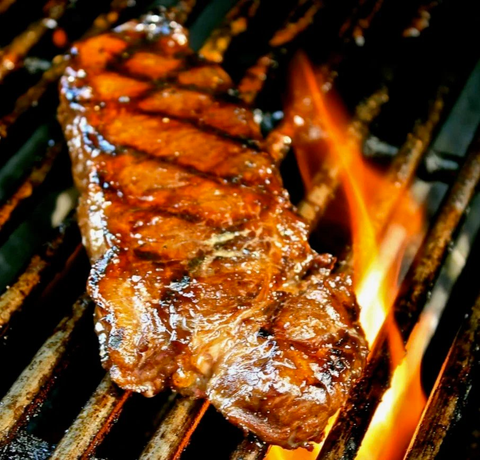 Whiskey marinated elk striploin on grill