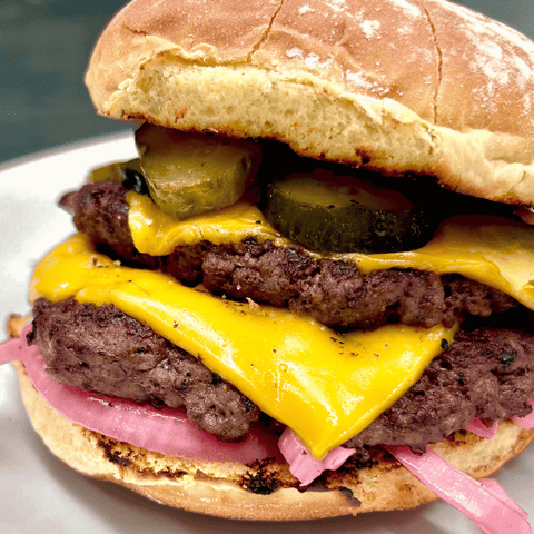 Ground Bison Smash Burger with pickles on a plate