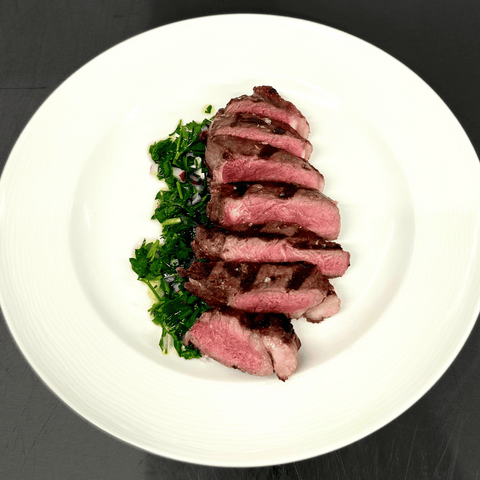 Bison NY Strip Steak on white plate