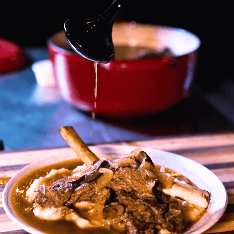 Smoked and braised ribs on plate with sauce